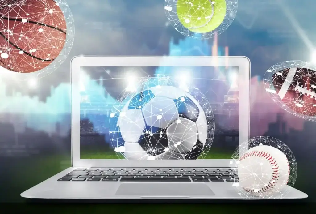 Computer umgeben von verschiedenen Sportbaellen